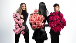 Three people holding pink rose bouquets showing what rose colors mean about affection and joy.